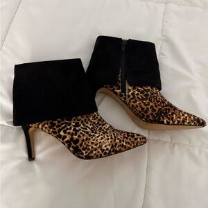 I.N.C leopard print ankle booties with a stiletto heel and black suede cuff.